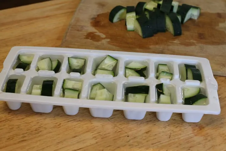 photo of cucumber chunks in ice cube trays for freezing