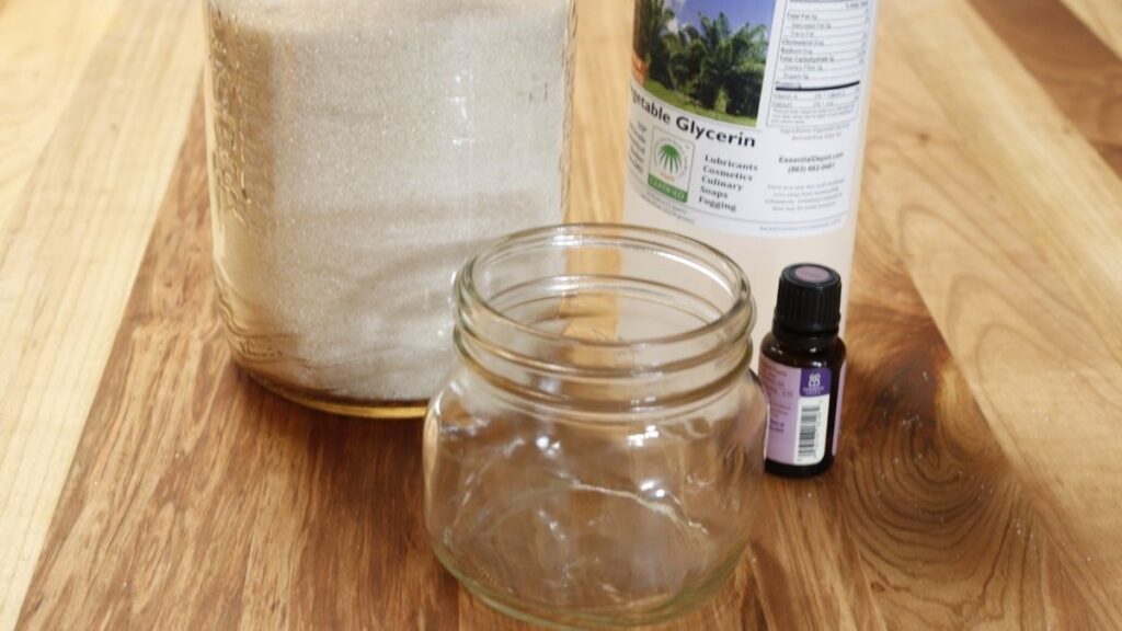 raw sugar, glycerin, lavender oil and mason jar on wood table